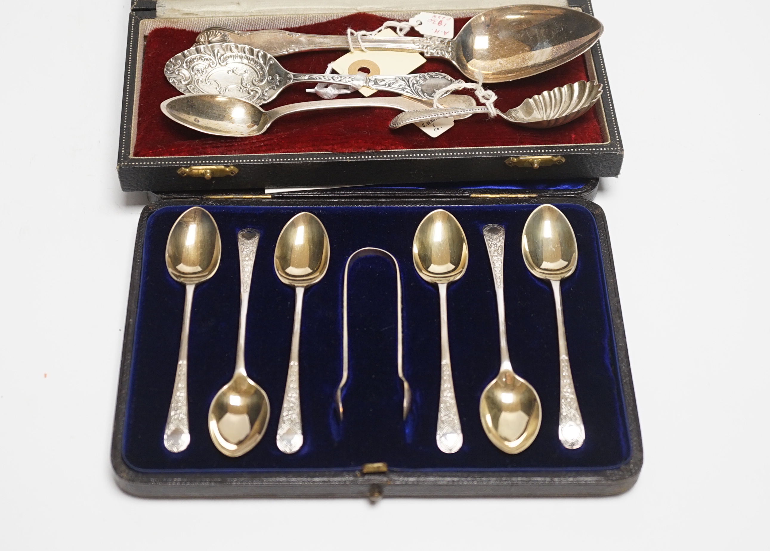 A cased set of six silver teaspoons and tongs and four other assorted silver or white metal spoons, including a caddy spoon.